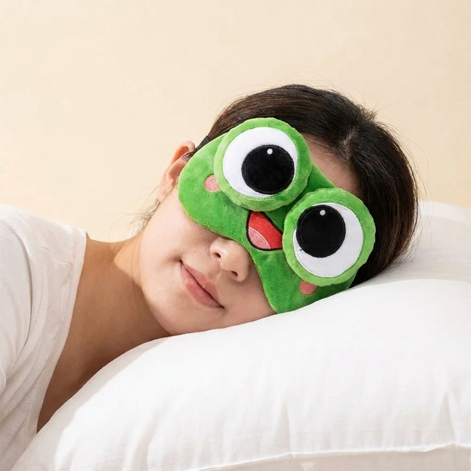 Sleeping in Pickles the Frog plush sleep mask